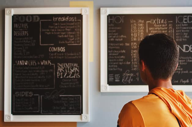 Person looking at a blackboard menu