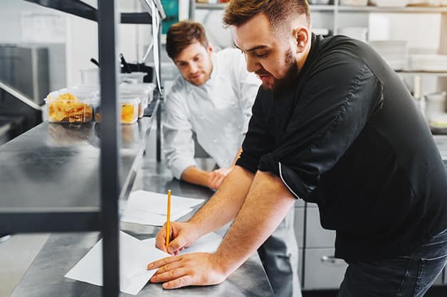 Chef looking at prices of ingredients