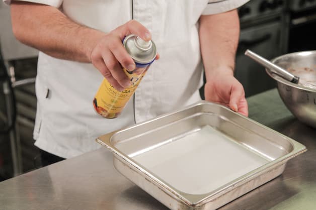 Greasing a tray with Gold'n Canola Oil Spray
