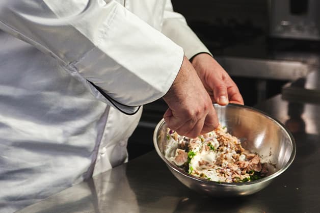 Mixing tuna mix in bowl