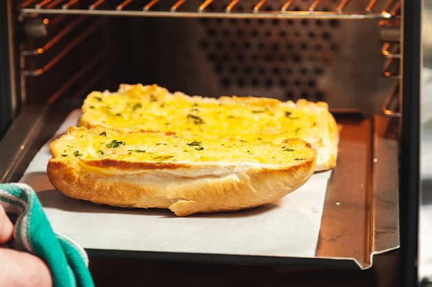 Toasted Garlic Bread Coming Out of Oven