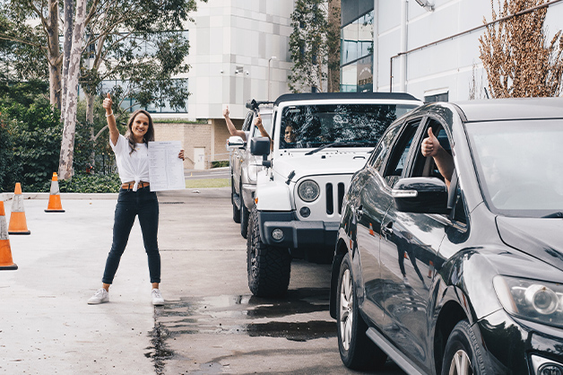 People give the thumbs up at a drive through stock collection