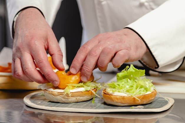 Place three prawns per burger on top of the lettuce