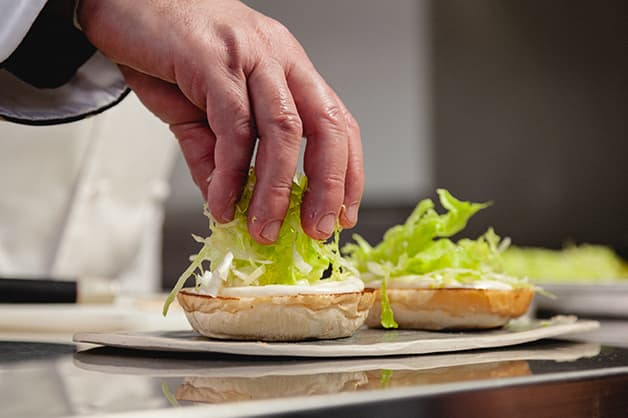 Layer the lettuce on top of the Aioli