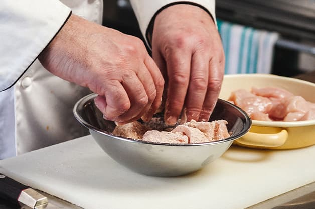 Battering chicken in a bowl