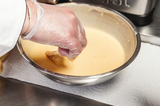 Adding the chicken nuggets to the batter mix