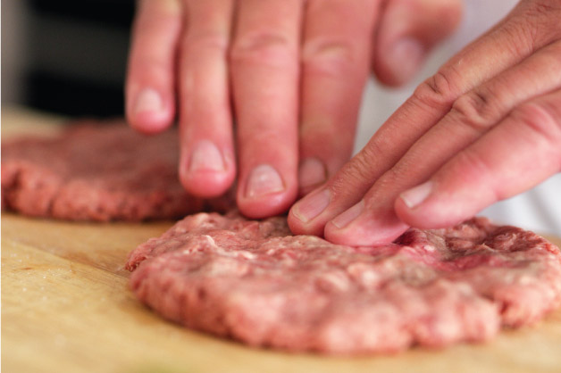 Chef pressing mince meat