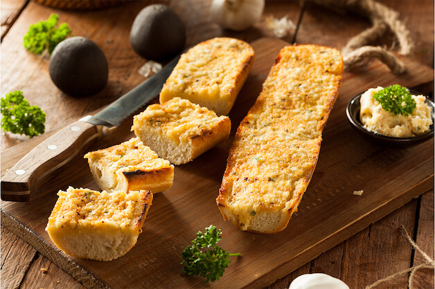 cheesy garlic bread on a board