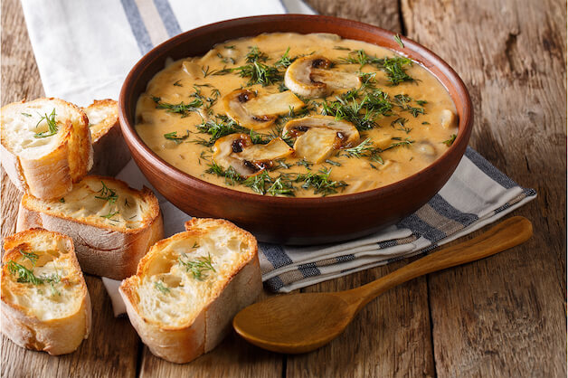 Mushroom soup on a bowl with a side of bread