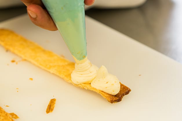 Piping custard on pastry