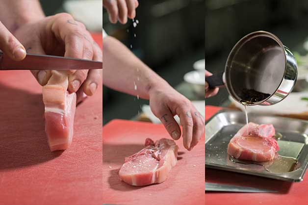 The chef is cleaning the pork cutlets