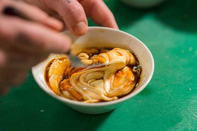 Action image of the chef creating his spicy mayonnaise