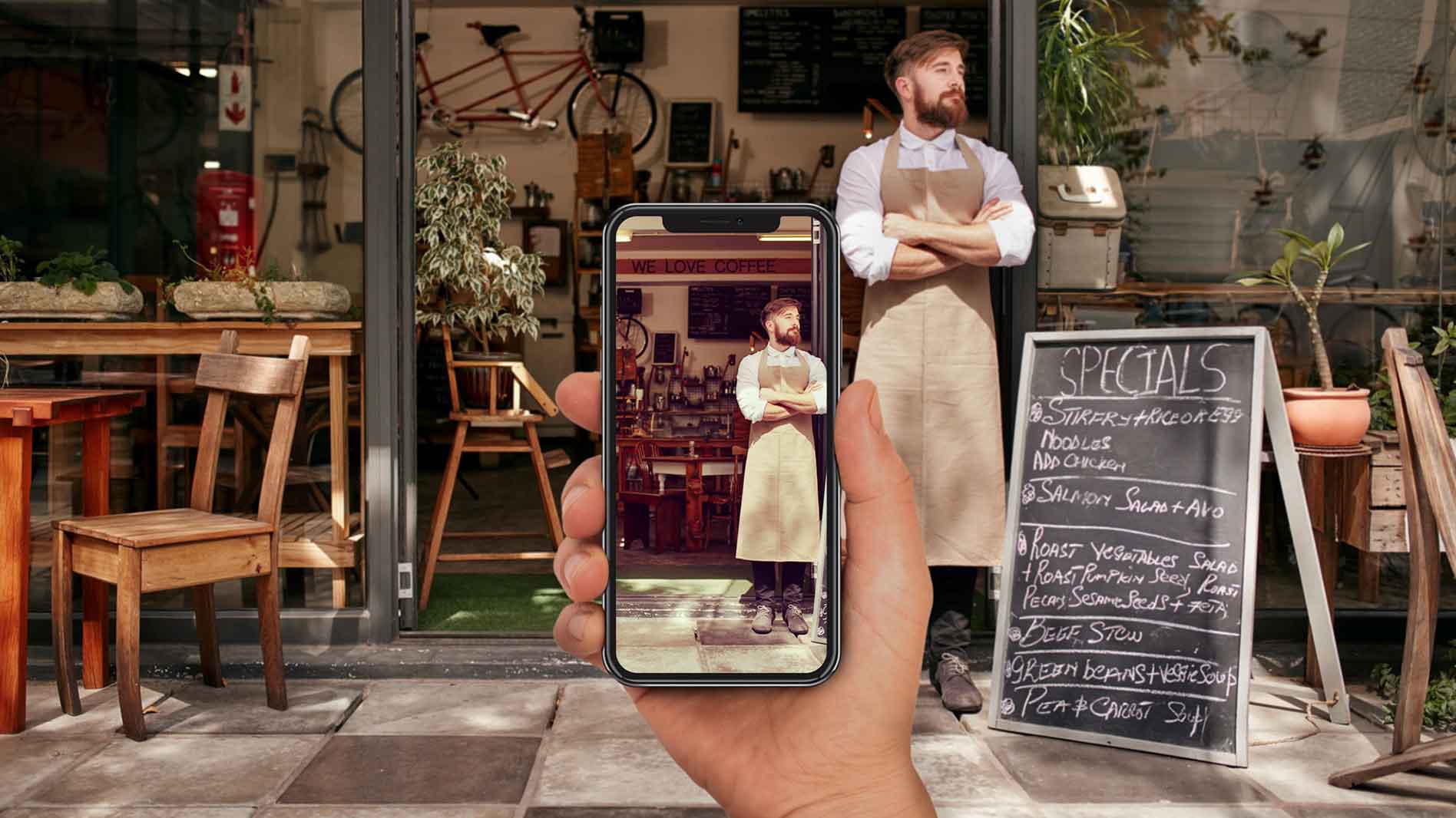 A person taking a photo of a chef standing outside a venue