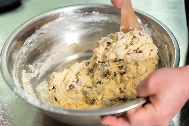 Chef is seen stirring in the wet ingredients