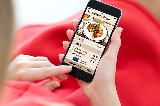 Person is pictured ordering food on their phone