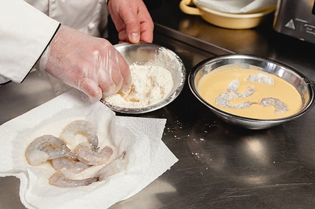 Prepping the prawns with the batter