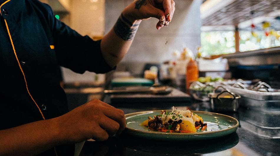 A chef in the kitchen prepping a meal